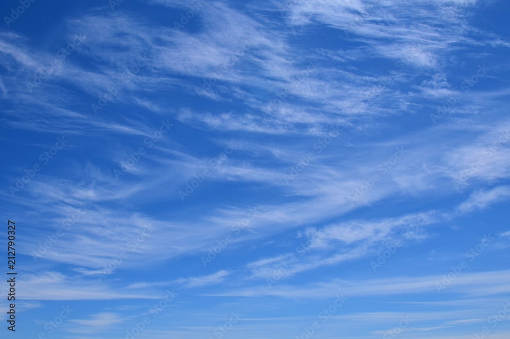 blue sky with light feathered clouds for backgrounds