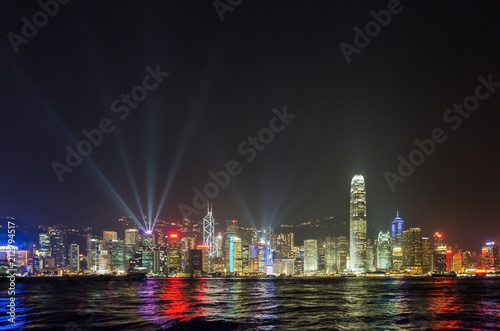 Hong Kong city skyline with light show and reflections on the water  seen from Kowloon