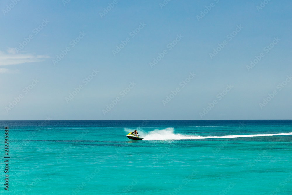 Jet ski rider on tropical pristine beach in Barbados Jet ski rider on tropical pristine beach in Barbados