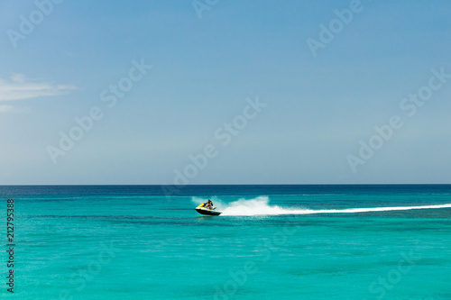 Jet ski rider on tropical pristine beach in Barbados © Zstock