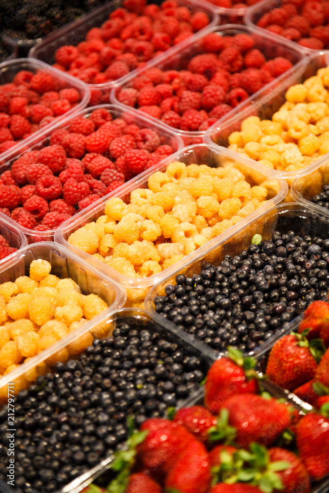 Colourful mix of different fresh berries at market