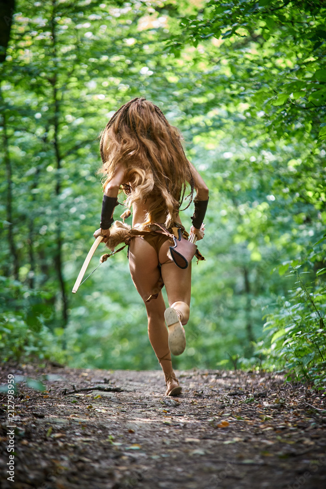 Amazon girl running in the forest on a forest path Stock Photo | Adobe Stock