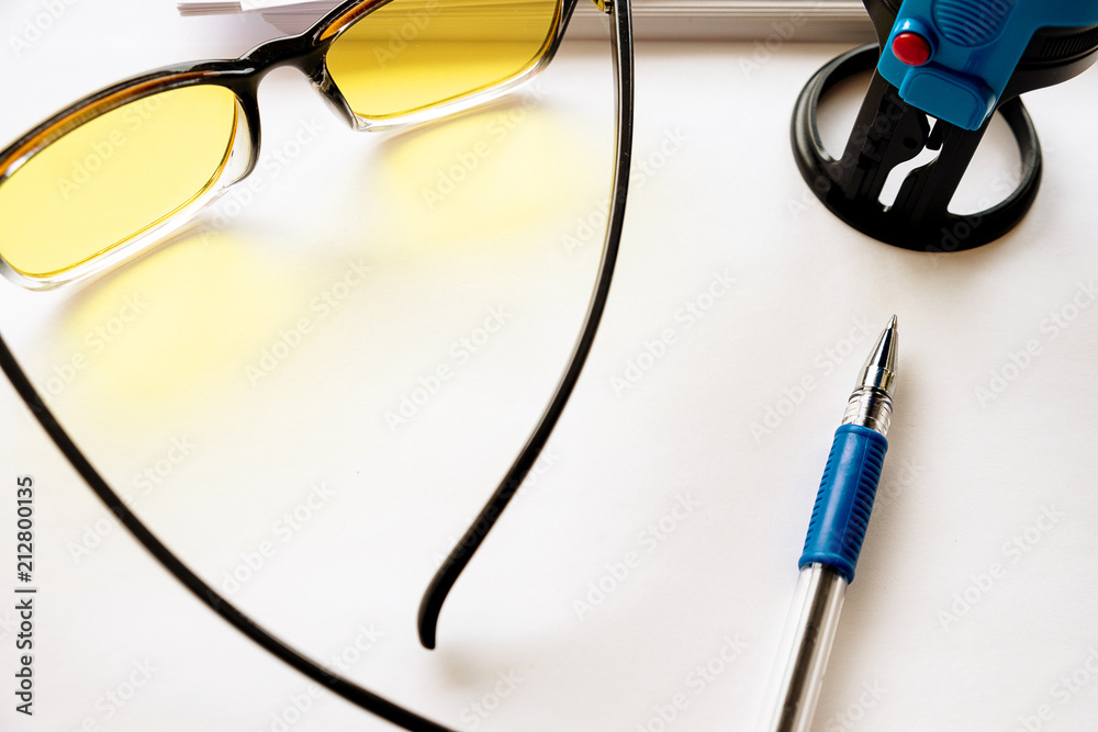 a view from above on glasses located on a table with paper and a seal a view from above on glasses located on a table with paper and a seal