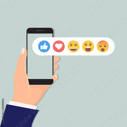 Hand holding smartphone with social network feedback emoticons