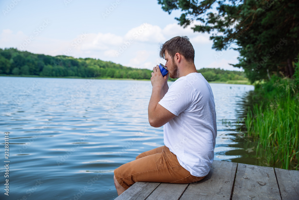 man drinking coffee with beautiful lake view man drinking coffee with beautiful lake view