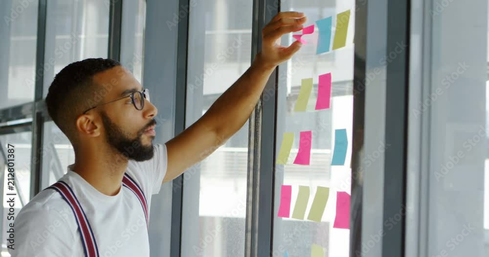 Male architect writing on sticky notes 4k