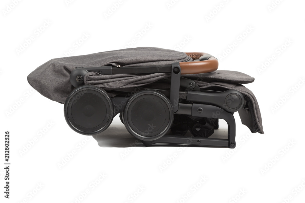 Baby carriage in folded condition for transportation on a trip. Baby carriage in folded condition for transportation on a trip.