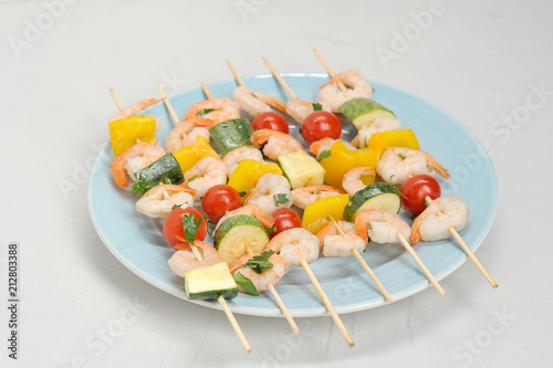 Shampers with shrimps and vegetables for grilling. View from above. Close-up. White background.  photo