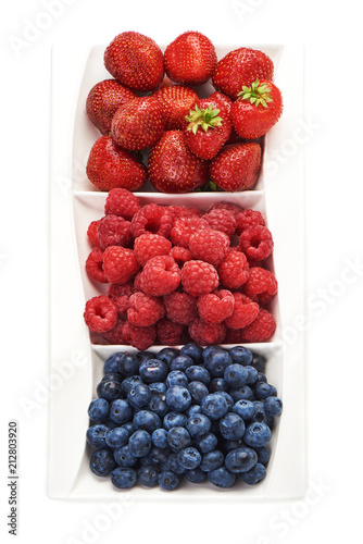 A mixed arrangement. Assorted berries including blueberries  raspberries and strawberry  isolated on white background. Top view.