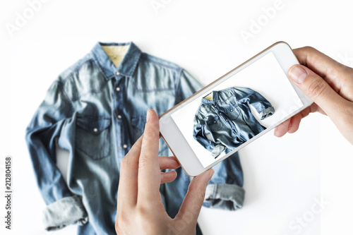 Woman taking a photo of a jean shirt photo