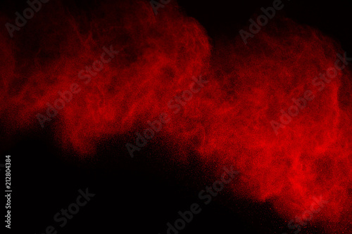 Abstract red powder splatted background,Freeze motion of color powder exploding/throwing color powder,color glitter texture on white background.