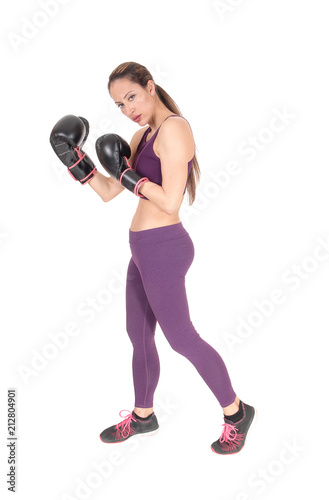 Slim woman standing in workout outfit and boxing