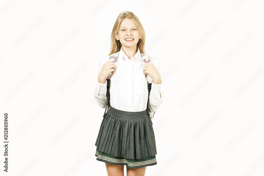 Beautiful blonde teenage girl with charming smile in schoolgirl uniform  wearing pleated skirt, white shirt, hands on backpack straps. Back to  school sale concept. Background, copy space, close up. Photos | Adobe