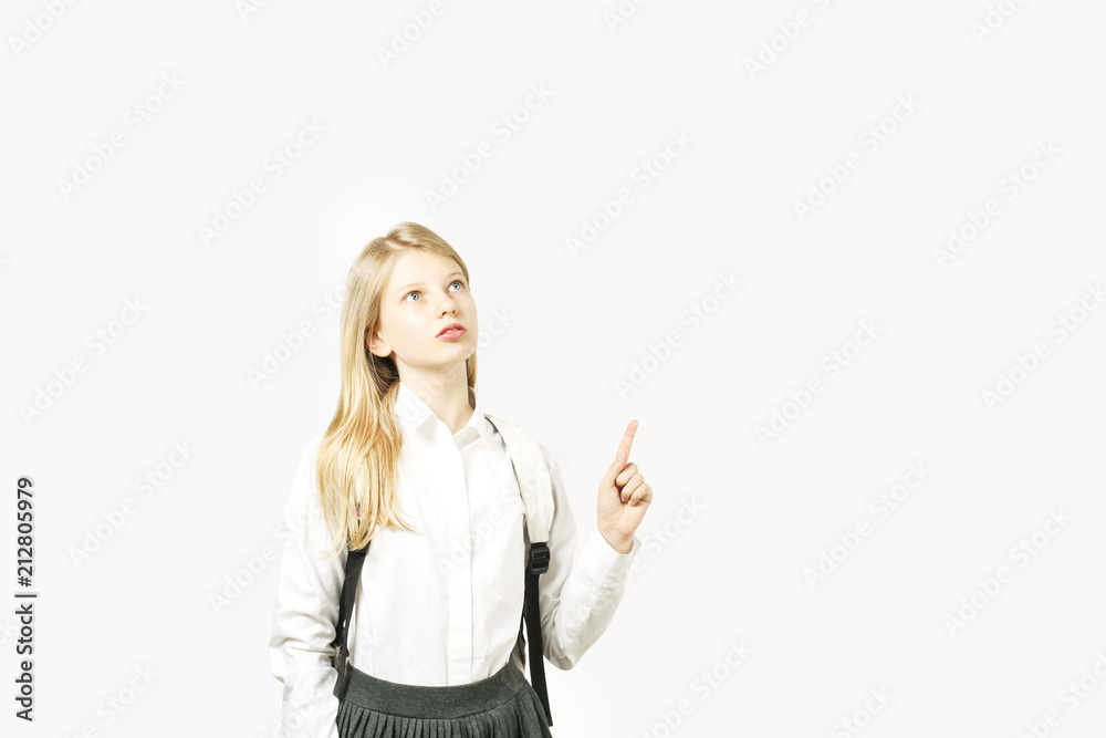 Portrait of a smiling young woman pointing up, isolated on white background Portrait of a smiling young woman pointing up, isolated on white background