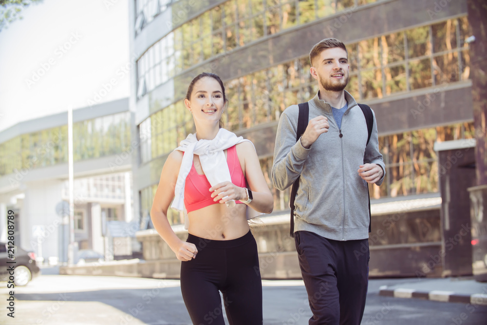young couple of runners on the street, healthy lifestyle concept