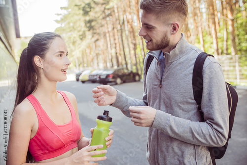 young couple runners talking on the street, the concept of a healthy lifestyle