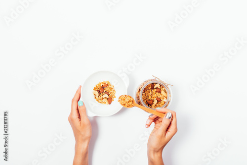 Woman making a healthy granola breakfast
