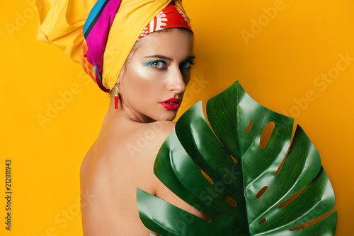 girl behind tropical leaf