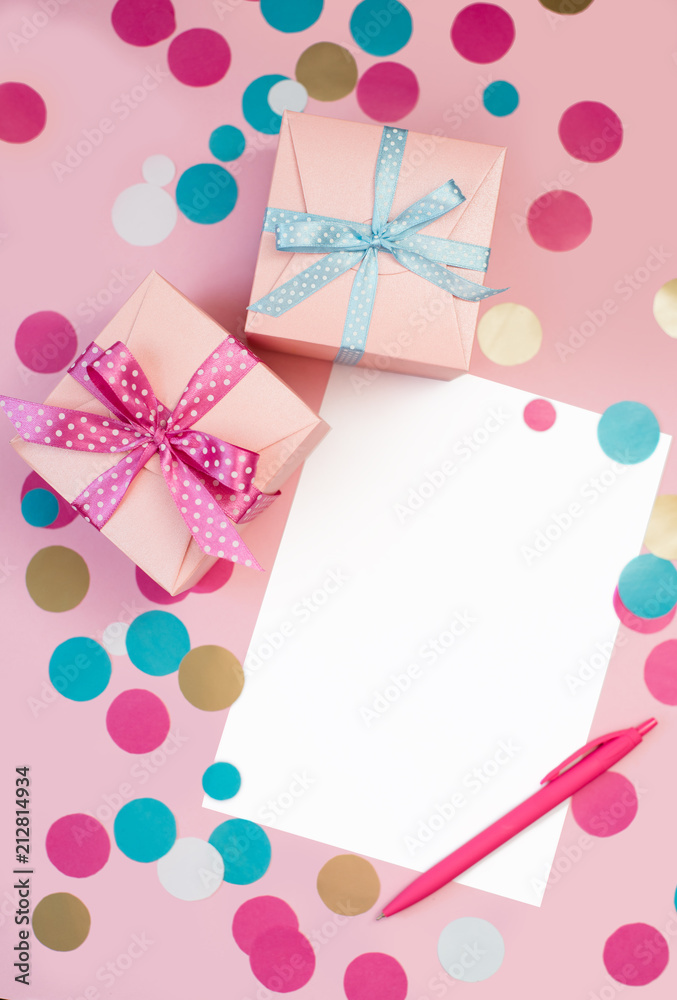 Decorated boxes, confetti and blank white sheet of paper.