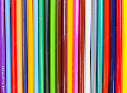 Bright colored pencils. Creative supplies background.