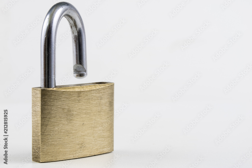 Brass padlock on a white table. Accessories for locking and securing against burglary. Brass padlock on a white table. Accessories for locking and securing against burglary.