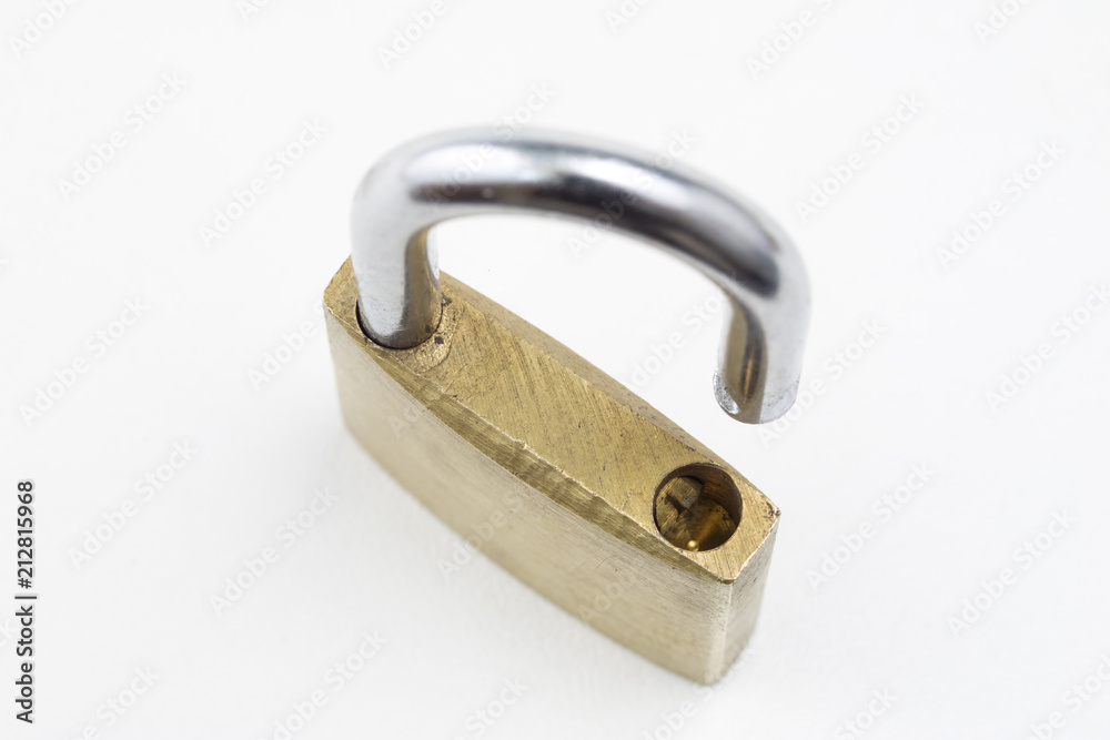 Brass padlock on a white table. Accessories for locking and securing against burglary. Brass padlock on a white table. Accessories for locking and securing against burglary.