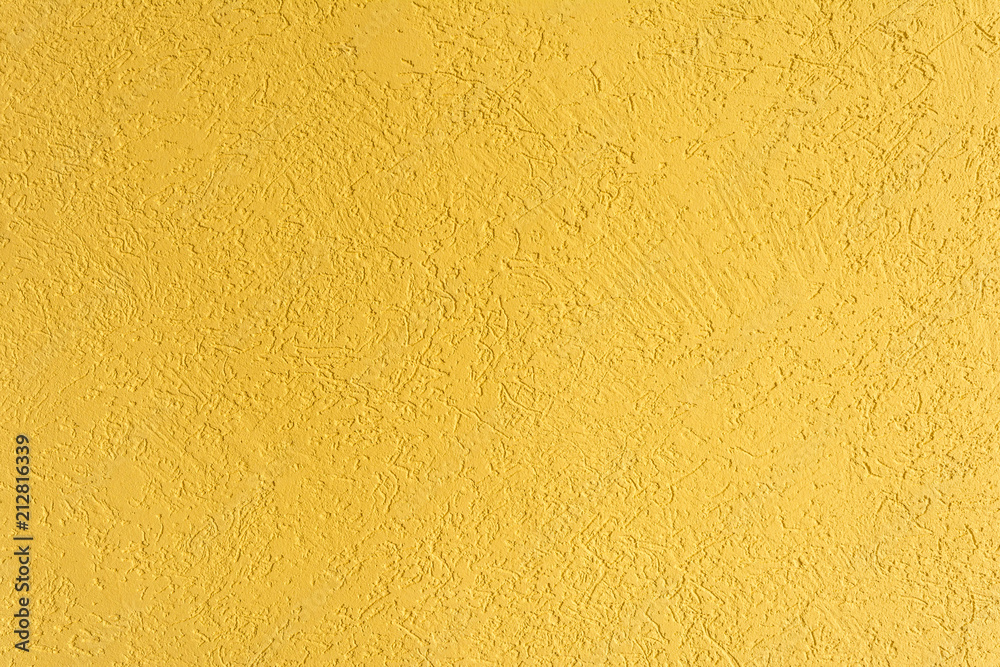 Fototapeta premium texture of the surface of the wall covered with decorative plaster of the woodworm type