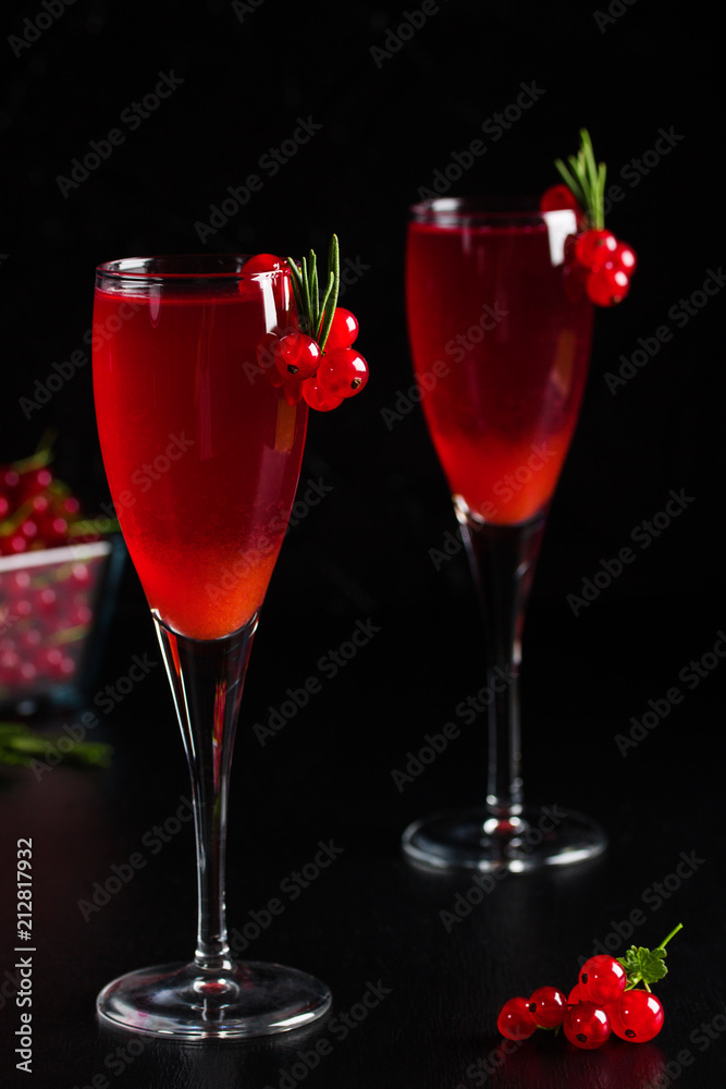 Two glasses redcurrant wine drink juice decorated with rosemary berries Two glasses redcurrant wine drink juice decorated with rosemary berries