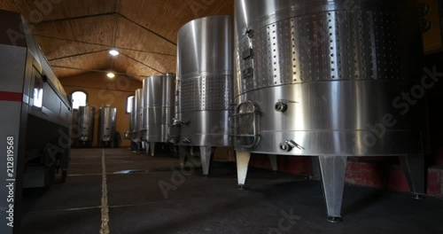 Wine production industry, detail of metal tanks. Slow traveling, panning and rotating at tanks room at floor level. Mendoza, Argentina. 