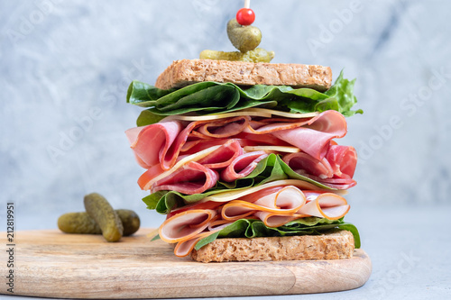Big sandwich with ham, deli meat and vegetables