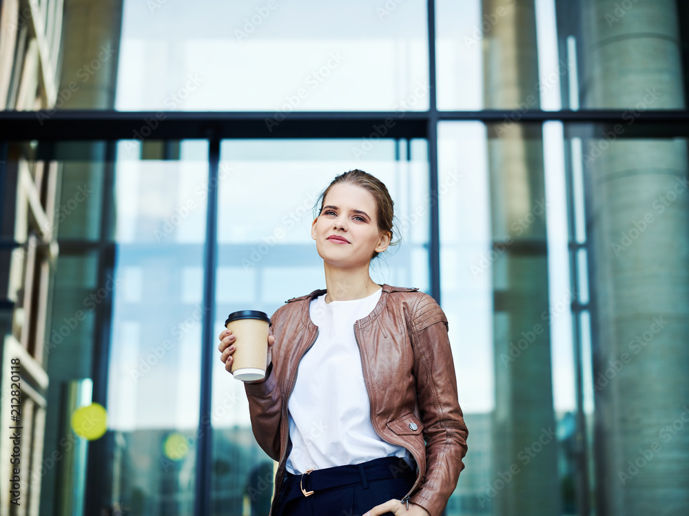 Cheerful businesswoman with coffee cup