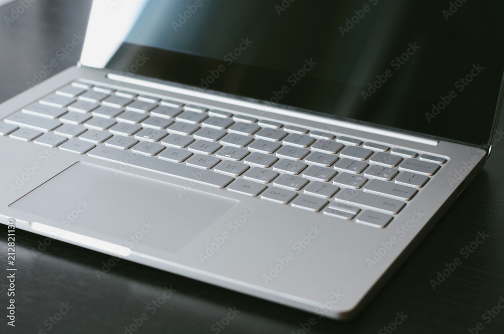 Open laptop with blank screen close-up on the table