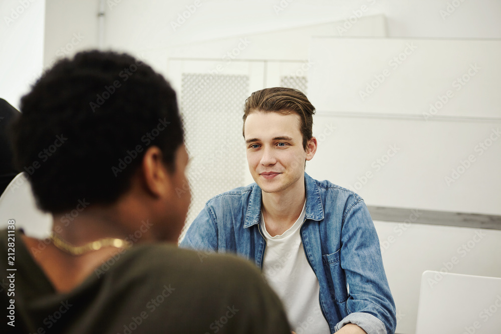 Young cheerful friends talking indoors Young cheerful friends talking indoors
