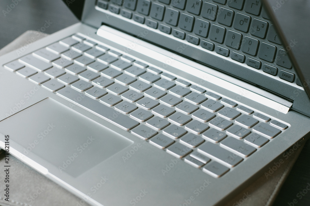Open laptop on the table. Computer keyboard in focus. Laptop buttons detailed Open laptop on the table. Computer keyboard in focus. Laptop buttons detailed