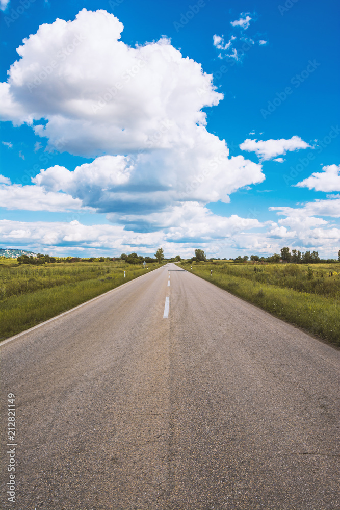 Open road and cumulus clouds, Vrsac, Serbia