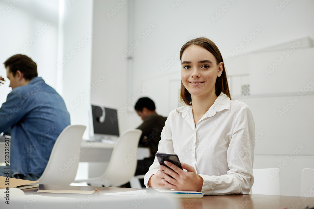 Charming student holding smartphone Charming student holding smartphone
