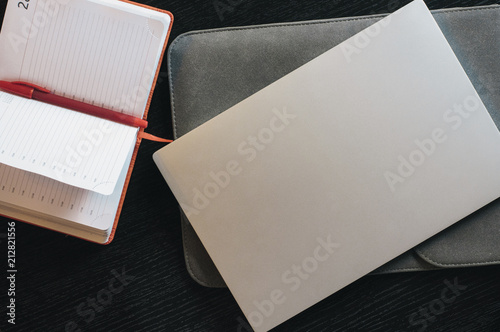 Pen with notebook and laptop on the office desk, workspace