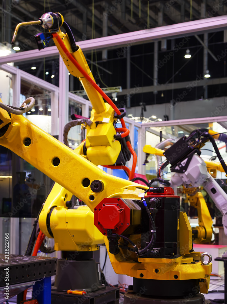 Robot arm with a gas burner on production line in a factory working for the humans