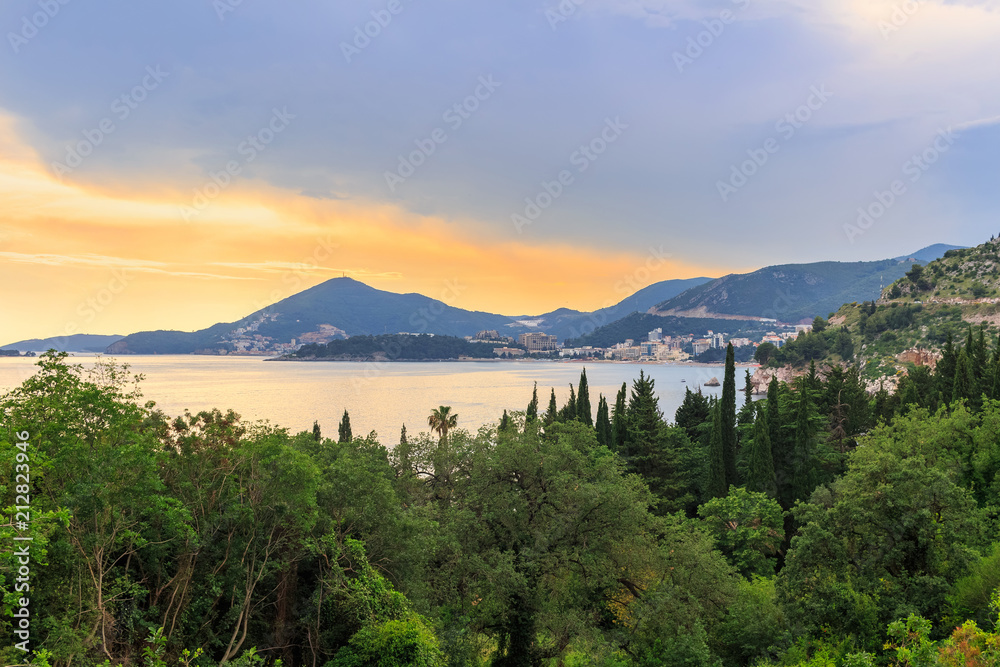 Awesome colorful sunset on Adriatic sea coastline in Montenegro, gorgeous summer seascape and nature landscape