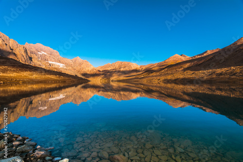 A beautiful view of Gangabal lake reflection in dry season with clear blue sky in a morning from Kashmir The Great Lakes Trek, India.