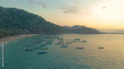 Fisherman boats docked in the shore Papuma beach an aerial view, Indonesia