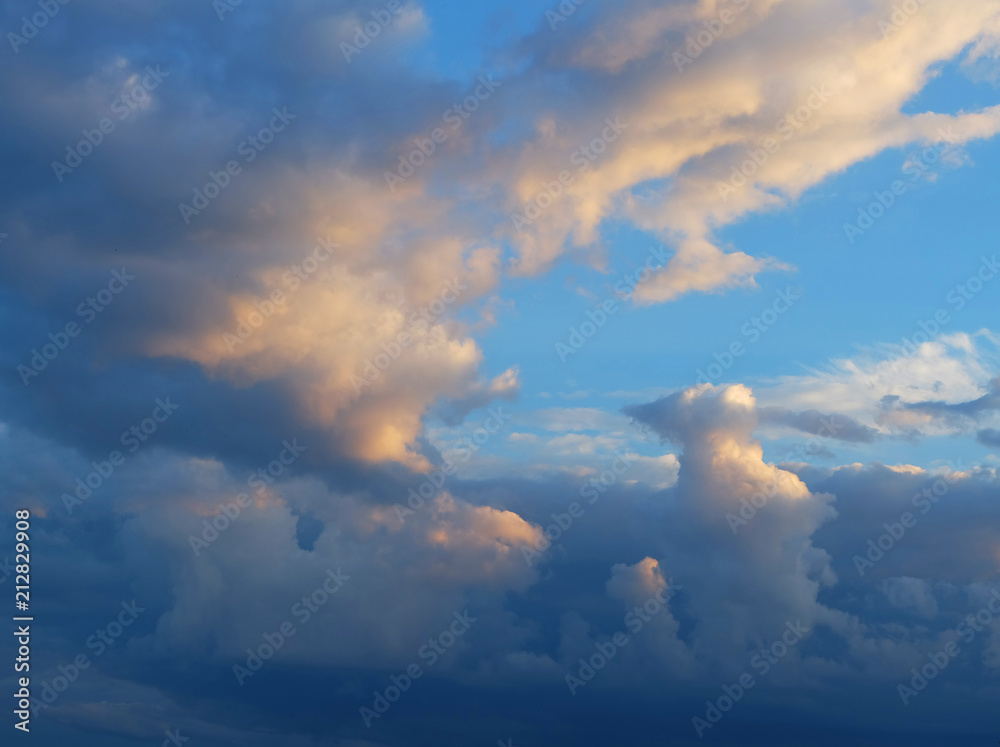 A blue sky with cumulus clouds at sunset .. A blue sky with cumulus clouds at sunset ..