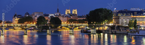 The night view of Seine river during the night with some famous touristic bridges like Pont des Arts and Pont Neuf, Paris, France.