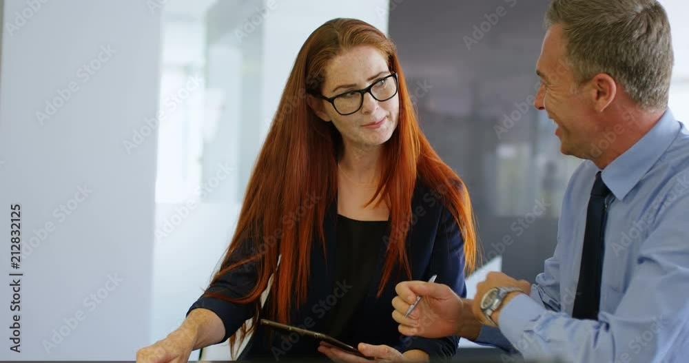 Business colleagues discussing over digital tablet 4k Business colleagues discussing over digital tablet 4k