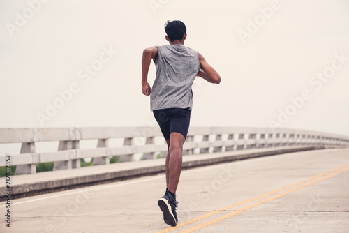 Black men runner are running on the bridge.black man doing workout outdoors,