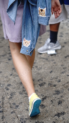 woman walking with cat's on jean jacket