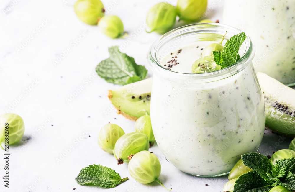 Smoothies from gooseberry, kiwi and yogurt with chia seeds, gray background, selective focus Smoothies from gooseberry, kiwi and yogurt with chia seeds, gray background, selective focus