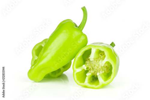 Group of one whole two halves of light green bell pepper isolated on white. photo