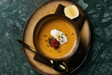 Lentil cream soup with baked lamb, cream fresh and spearmint. Delicious healthy soup food in bowl plate on table background, close-up, top view
