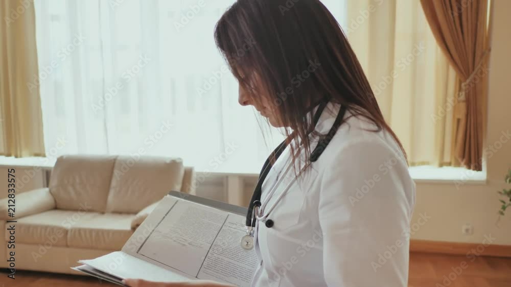 girl doctor walking in hospital with documents girl doctor walking in hospital with documents